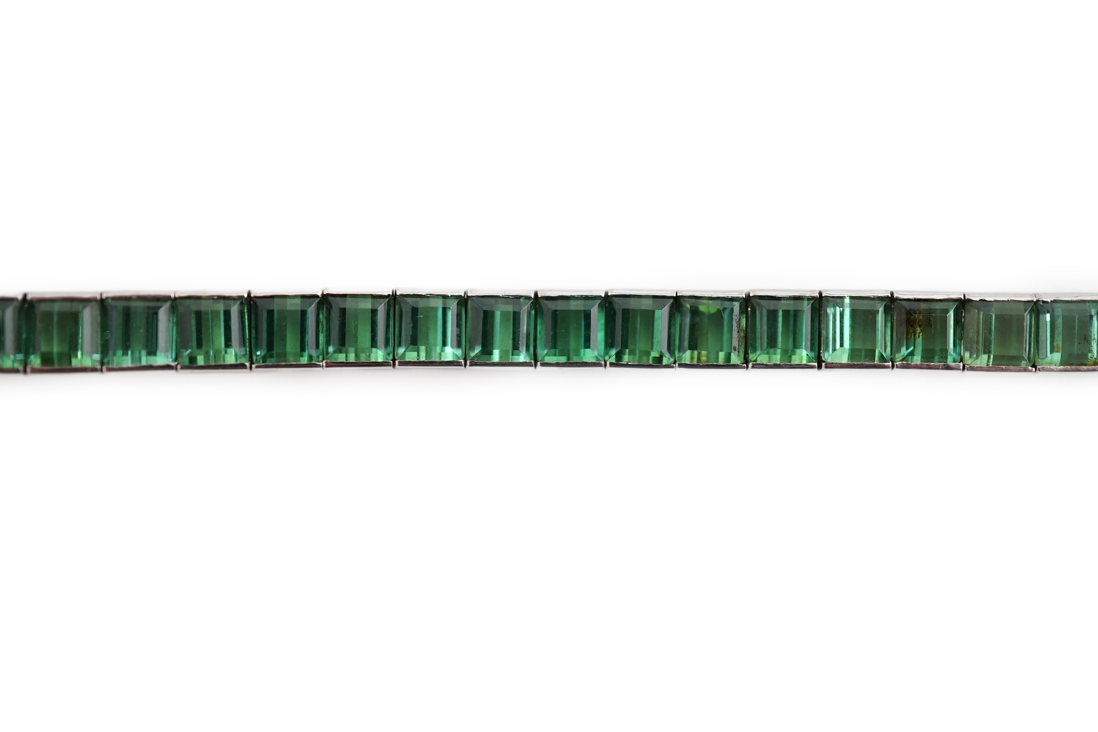 A white gold (tests as 18ct) and green tourmaline line bracelet